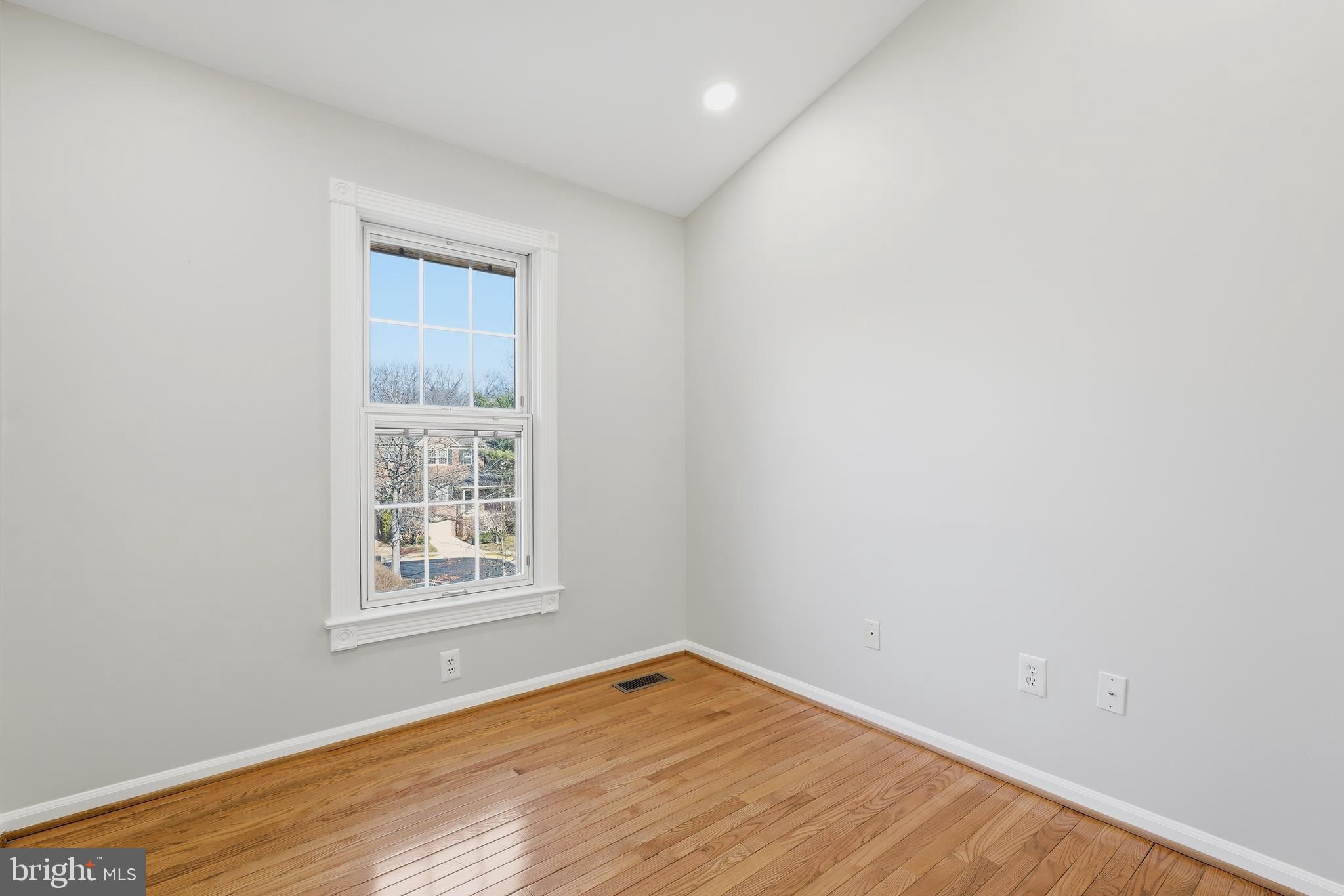 1472 Park Garden Lane Reston, VA 20194 - Photo 47 of 64 an empty room with wooden floor and windows
