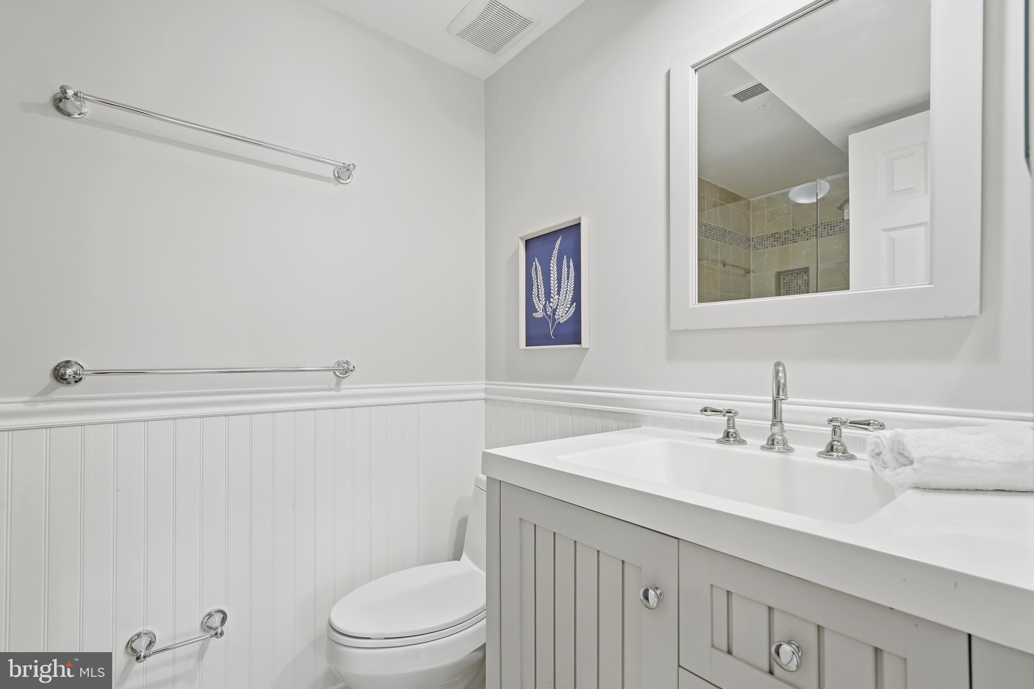 1472 Park Garden Lane Reston, VA 20194 - Photo 53 of 64 a bathroom with a sink a toilet and a mirror
