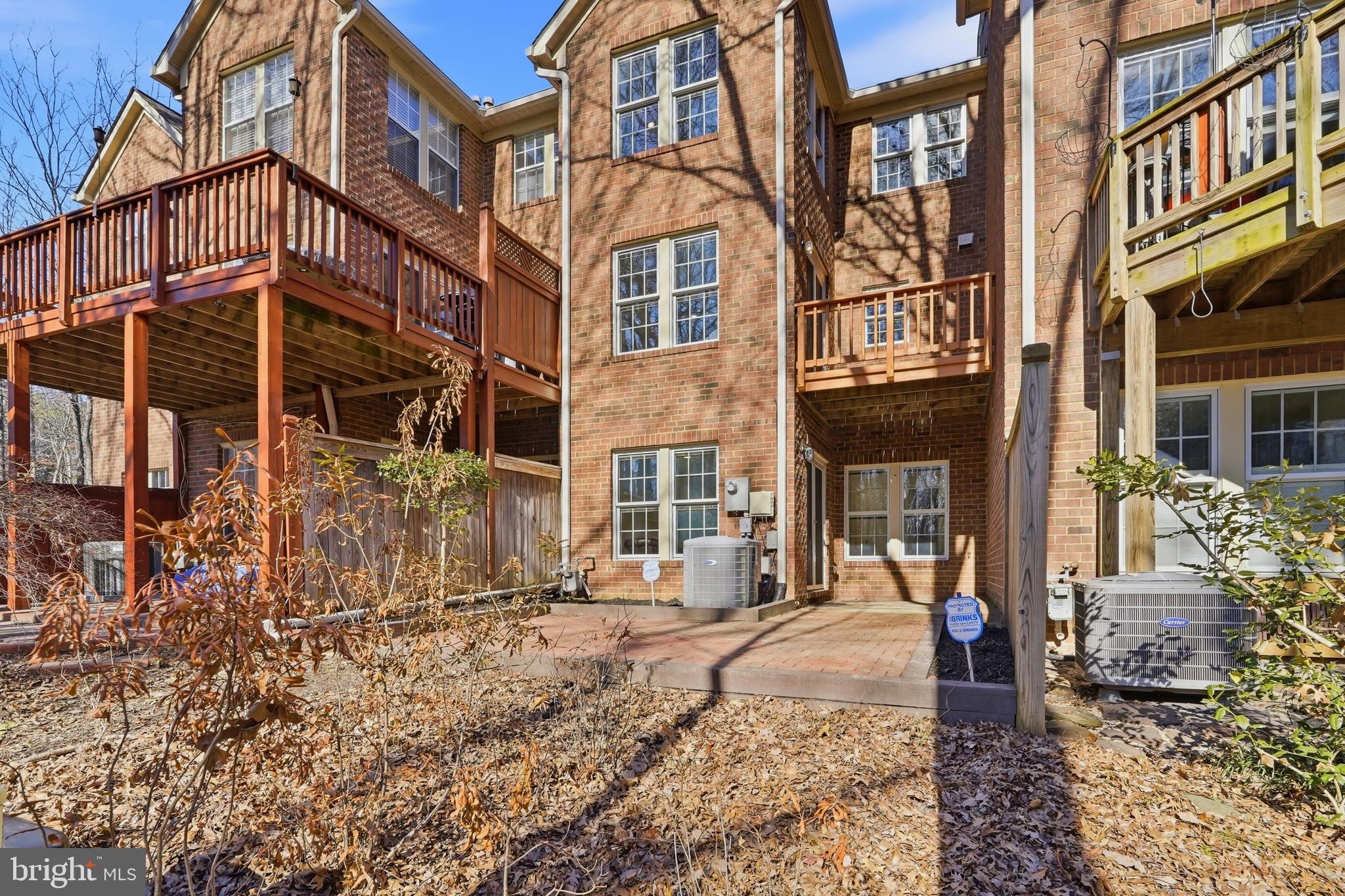 1472 Park Garden Lane Reston, VA 20194 - Photo 61 of 64 a front view of a residential apartment building with a yard