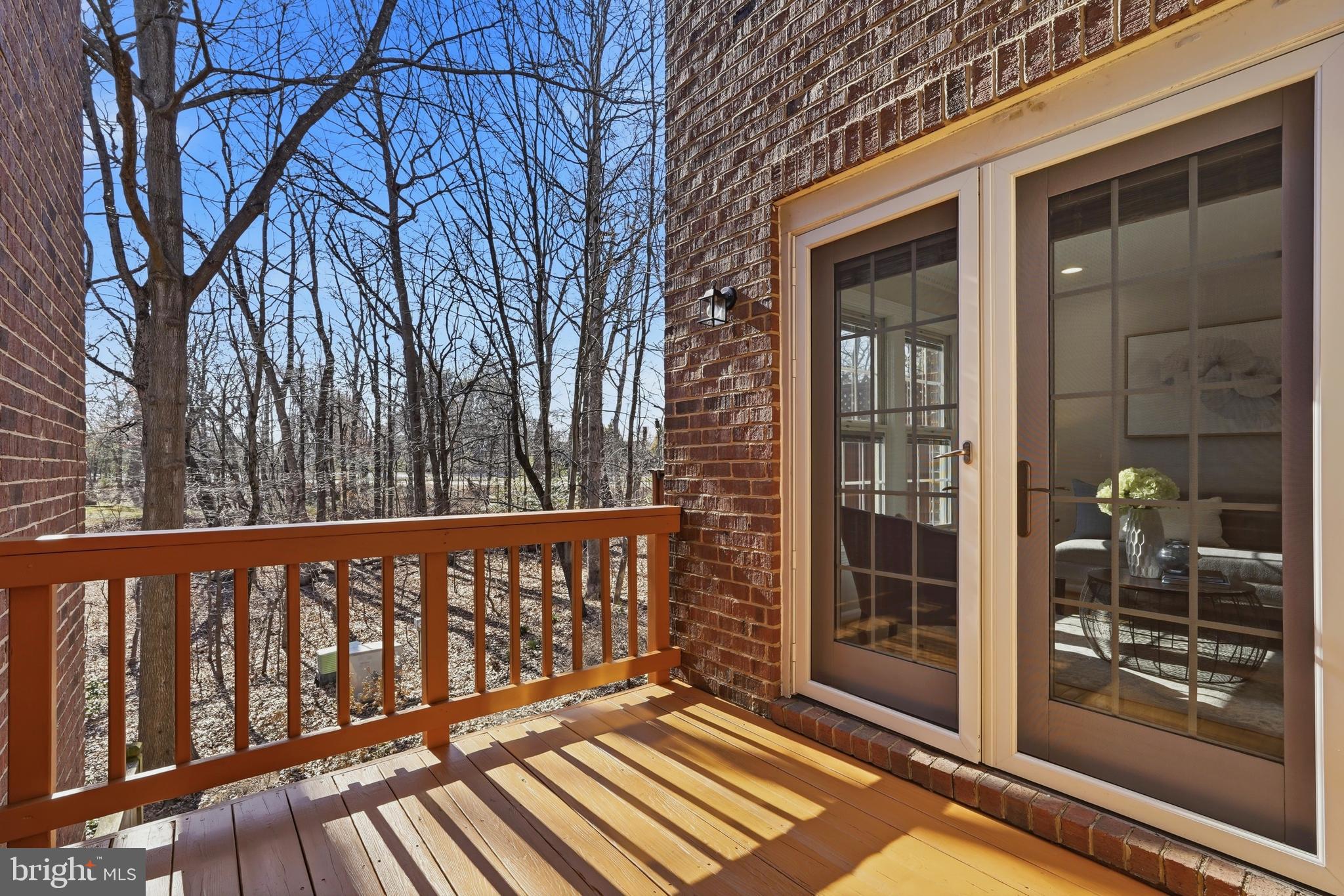 1472 Park Garden Lane Reston, VA 20194 - Photo 62 of 64 a view of a wooden balcony with a floor to ceiling window and wooden fence