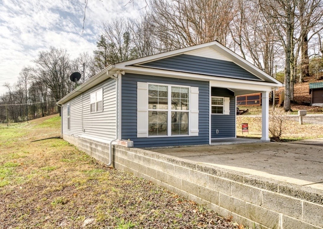 807 Clear Creek Road Pulaski, TN 38478 - Photo 2 of 17 a front view of a house with a yard and garage
