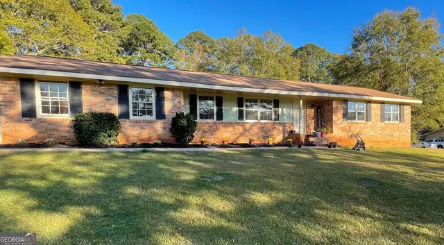 a front view of house with yard and green space