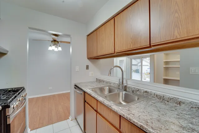 a kitchen with granite countertop a sink and a stove