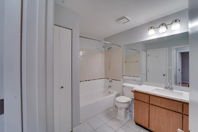 a bathroom with a sink a toilet and a large mirror