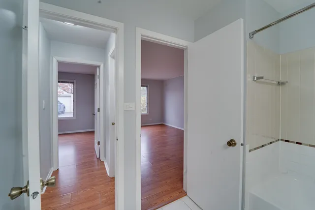 a view of a hallway with wooden floor