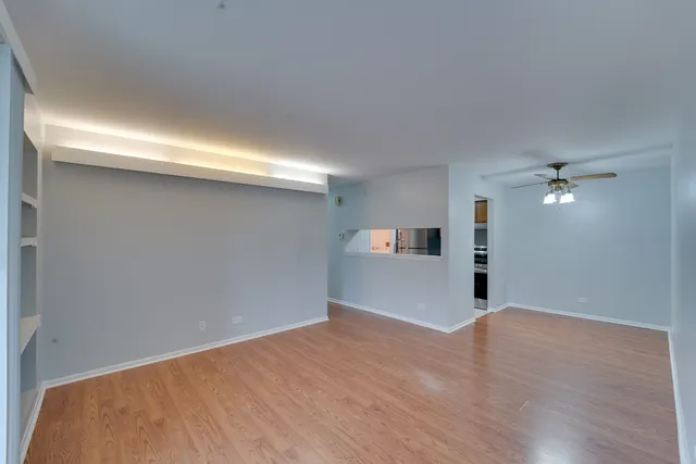 a view of empty room with wooden floor