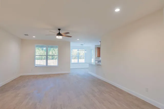 a kitchen with stainless steel appliances granite countertop a stove top oven a sink dishwasher and a refrigerator