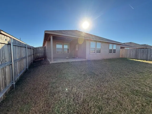 a view of a house with wooden fence