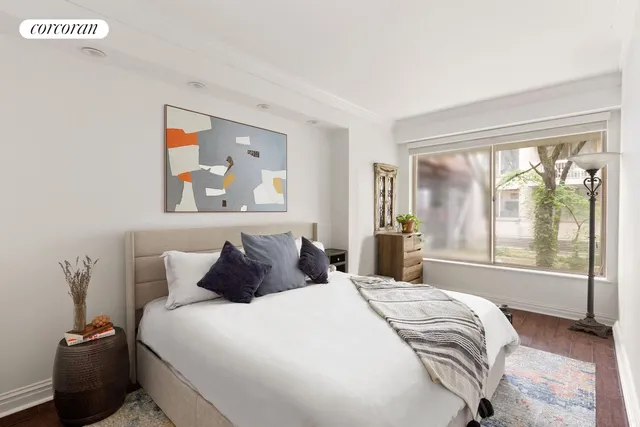 a bedroom with a large bed and a window