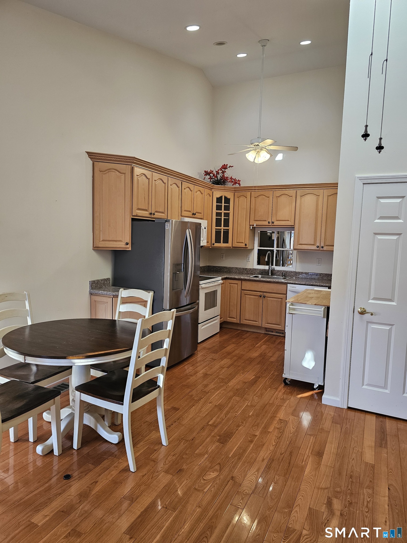 2 Park Avenue, Unit 3 Wolcott, CT 06716 - Photo 3 of 18 a kitchen with stainless steel appliances granite countertop a refrigerator a stove a sink dishwasher and a microwave with wooden floor