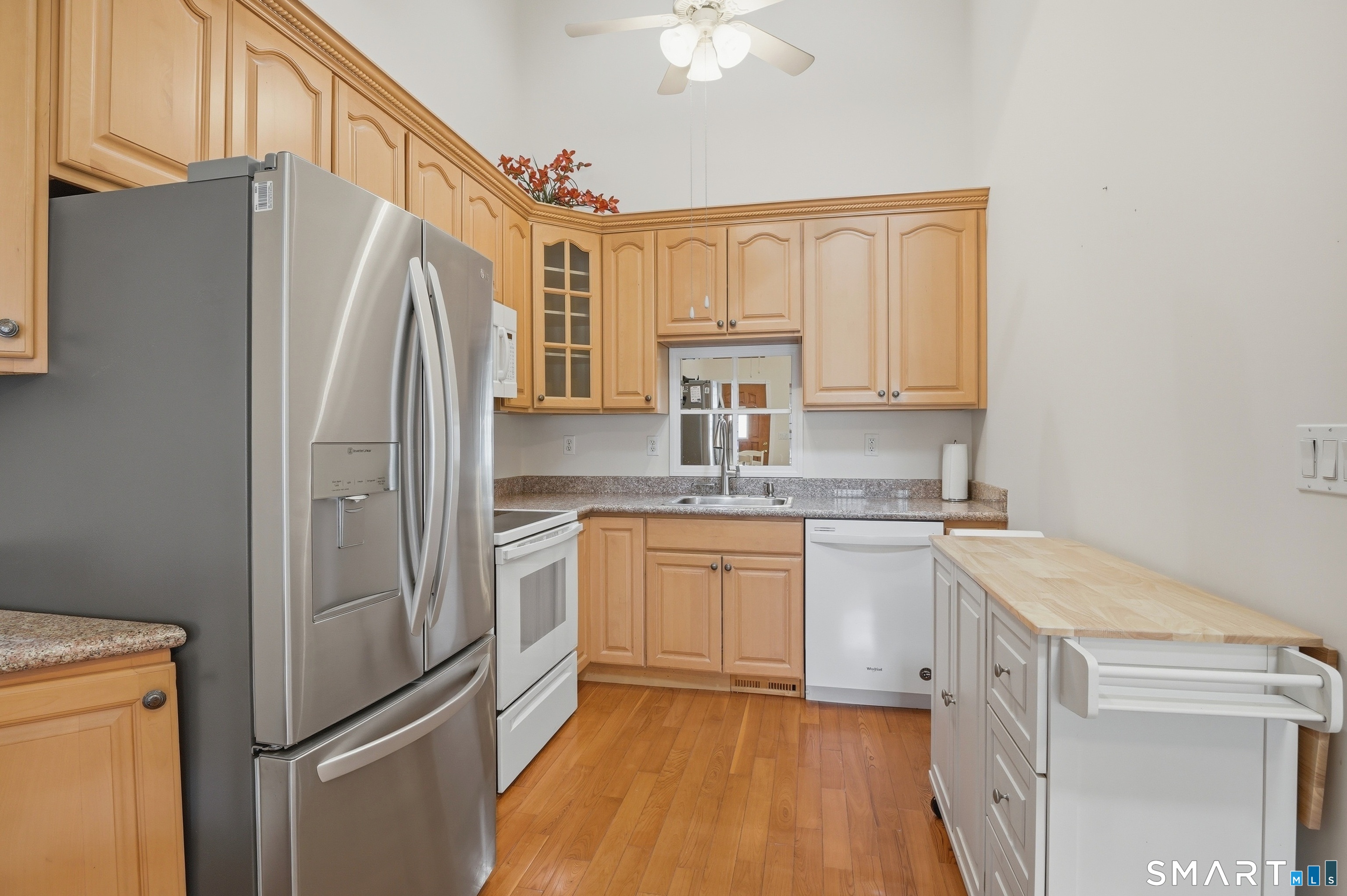2 Park Avenue, Unit 3 Wolcott, CT 06716 - Photo 7 of 18 a kitchen with a refrigerator a sink and dishwasher with white cabinets