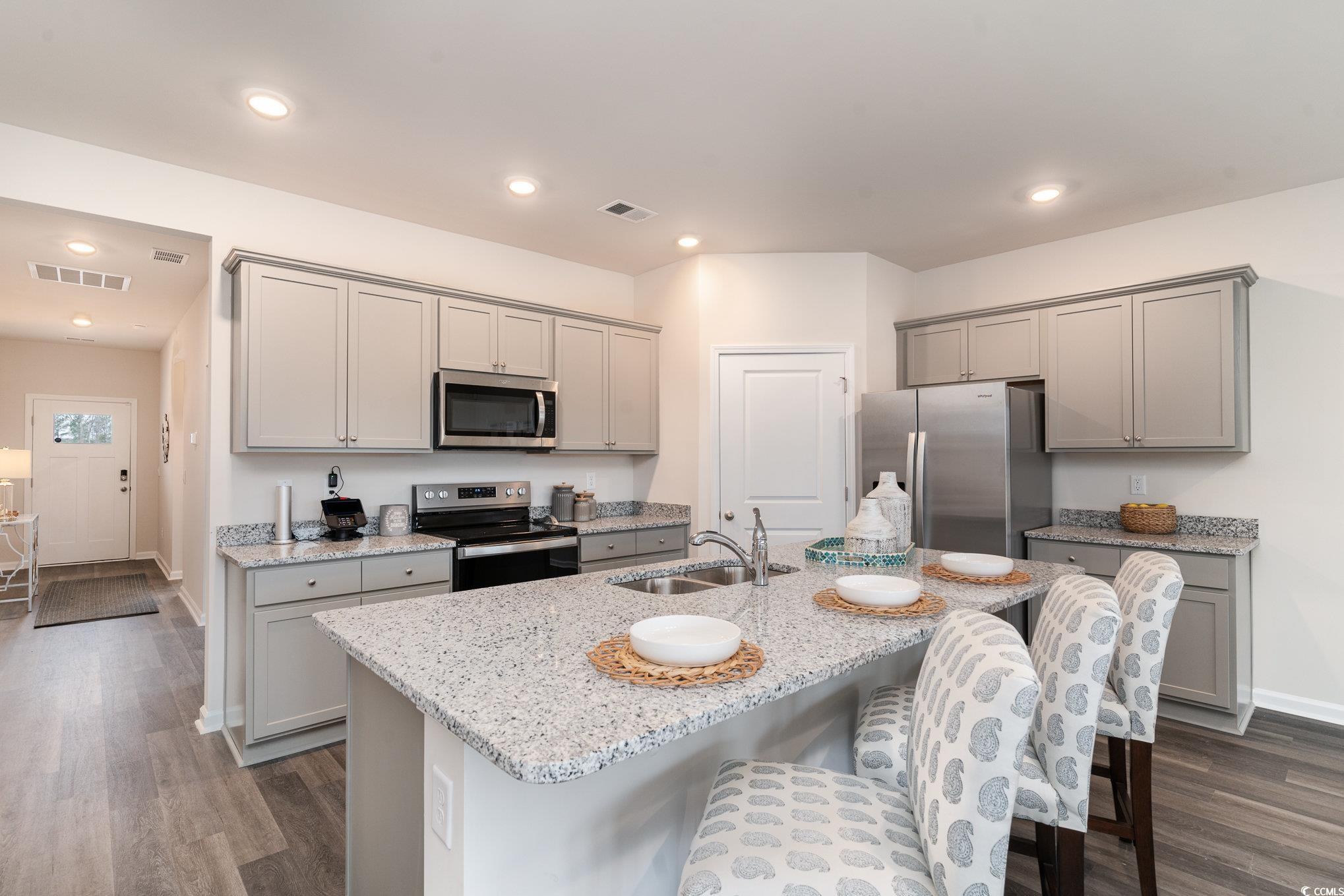 409 Glade Court Loris, SC 29569 - Photo 3 of 25 Kitchen with stainless steel appliances, gray cabinetry, a sink, dark wood-type flooring, and recessed lighting