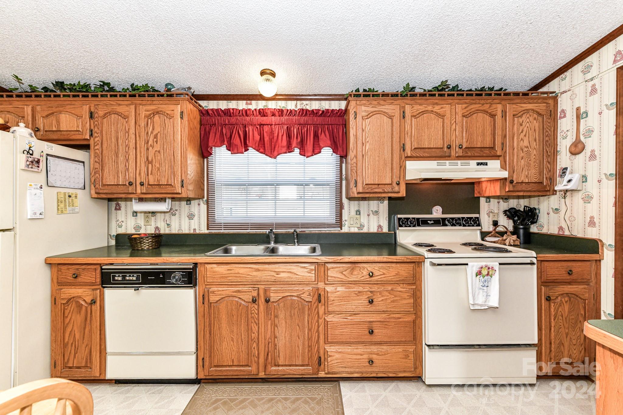 717 Clontz Long Road Monroe, NC 28110 - Photo 17 of 35 a kitchen with stainless steel appliances granite countertop a stove a sink and a refrigerator
