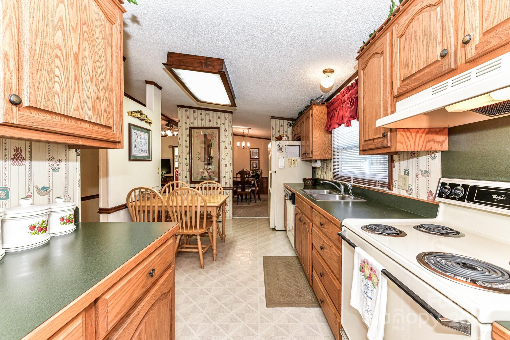 717 Clontz Long Road Monroe, NC 28110 - Photo 19 of 35 a kitchen with a stove a sink and a refrigerator