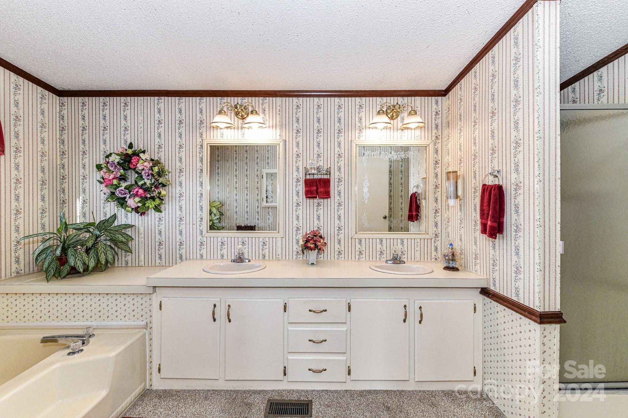 717 Clontz Long Road Monroe, NC 28110 - Photo 22 of 35 a bathroom with a double vanity sink and a mirror