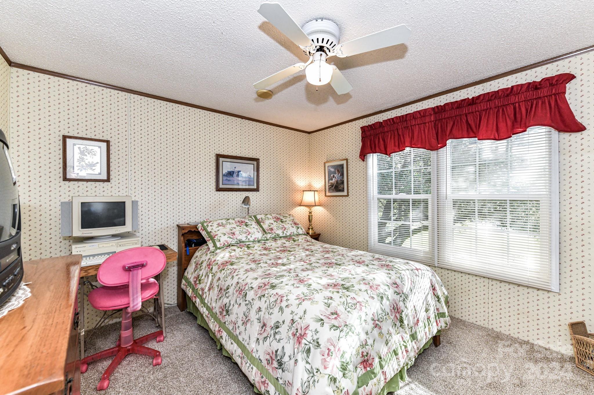 717 Clontz Long Road Monroe, NC 28110 - Photo 24 of 35 a bedroom with a bed a chandelier and a chair