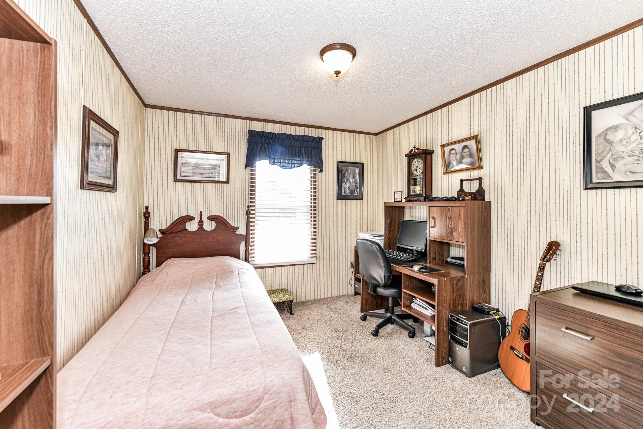 717 Clontz Long Road Monroe, NC 28110 - Photo 26 of 35 a bedroom with bed and a desk