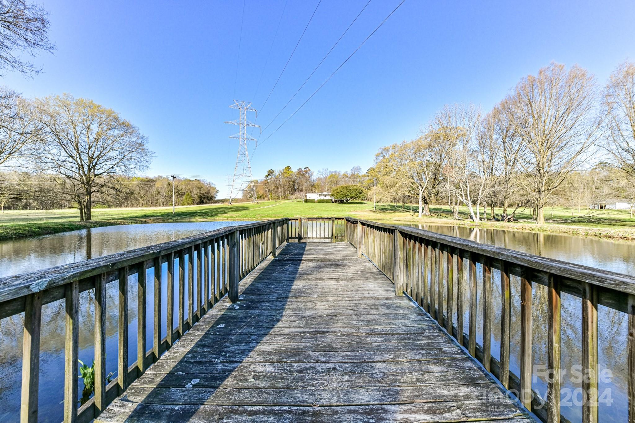 717 Clontz Long Road Monroe, NC 28110 - Photo 3 of 35 a view of a balcony with wooden floor and fence
