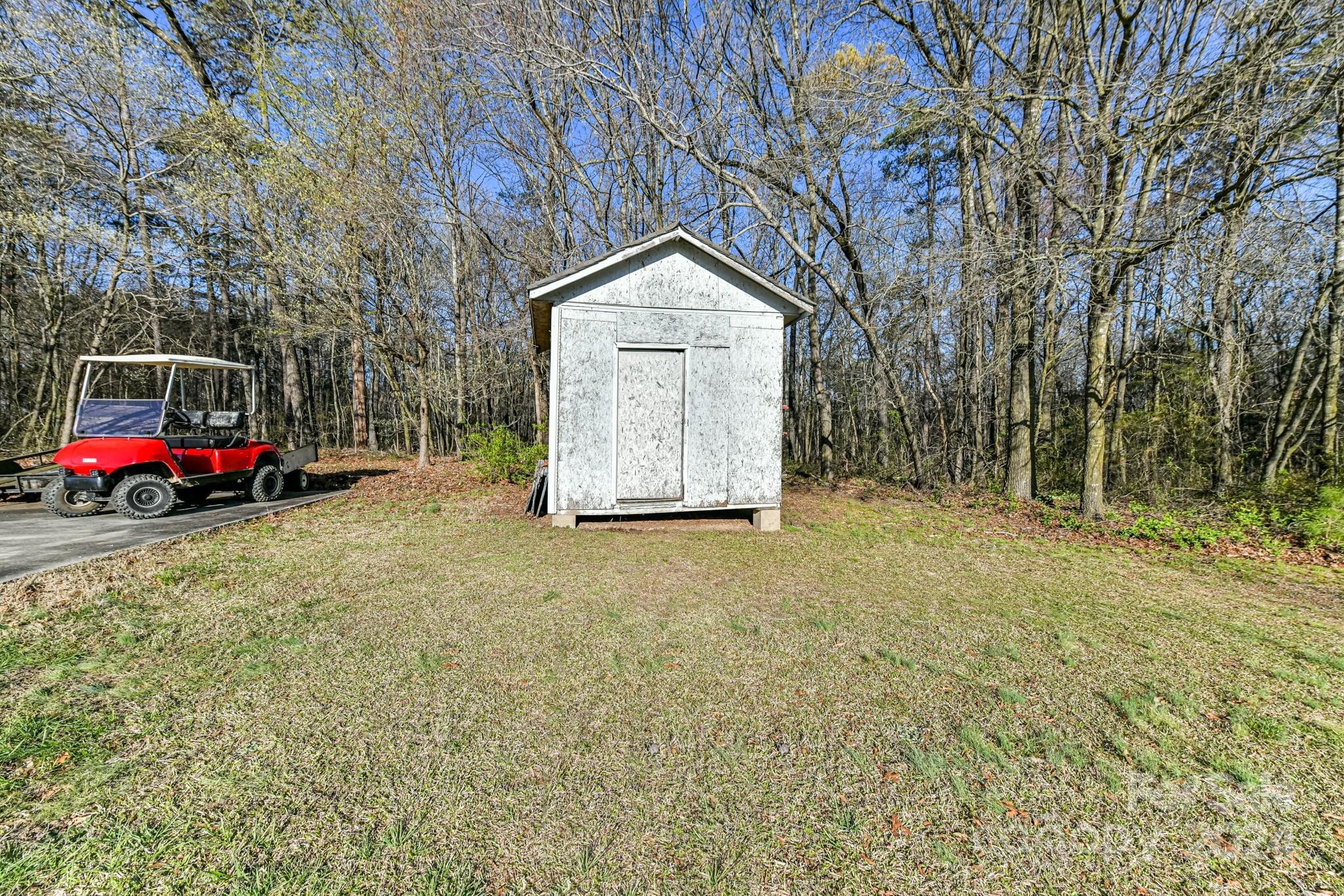 717 Clontz Long Road Monroe, NC 28110 - Photo 31 of 35 a backyard of a house with lots of green space and trampoline