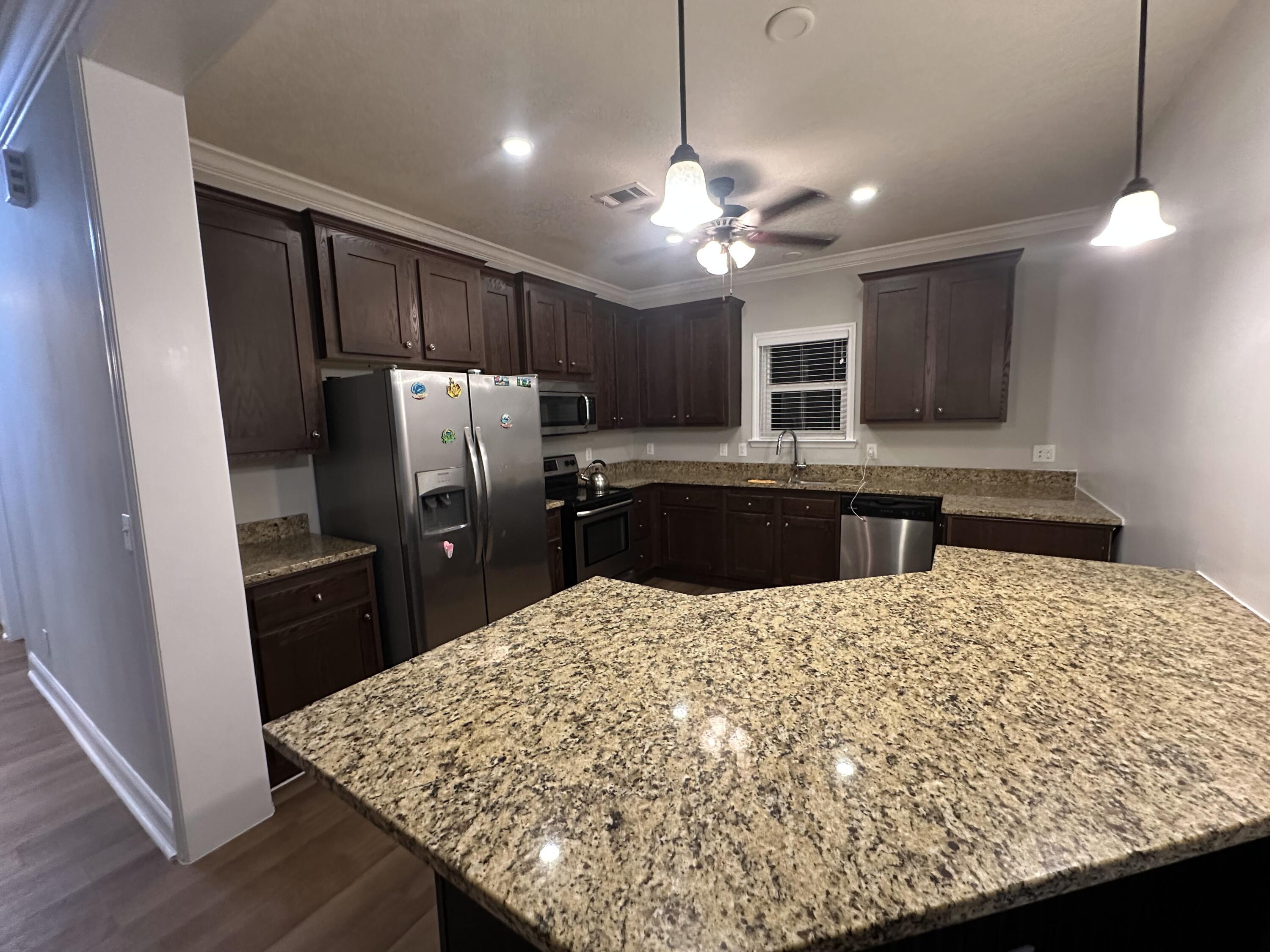 30964 Nathalie Road Big Pine Key, FL 33043 - Photo 2 of 10 a kitchen with kitchen island a counter top space appliances and cabinets