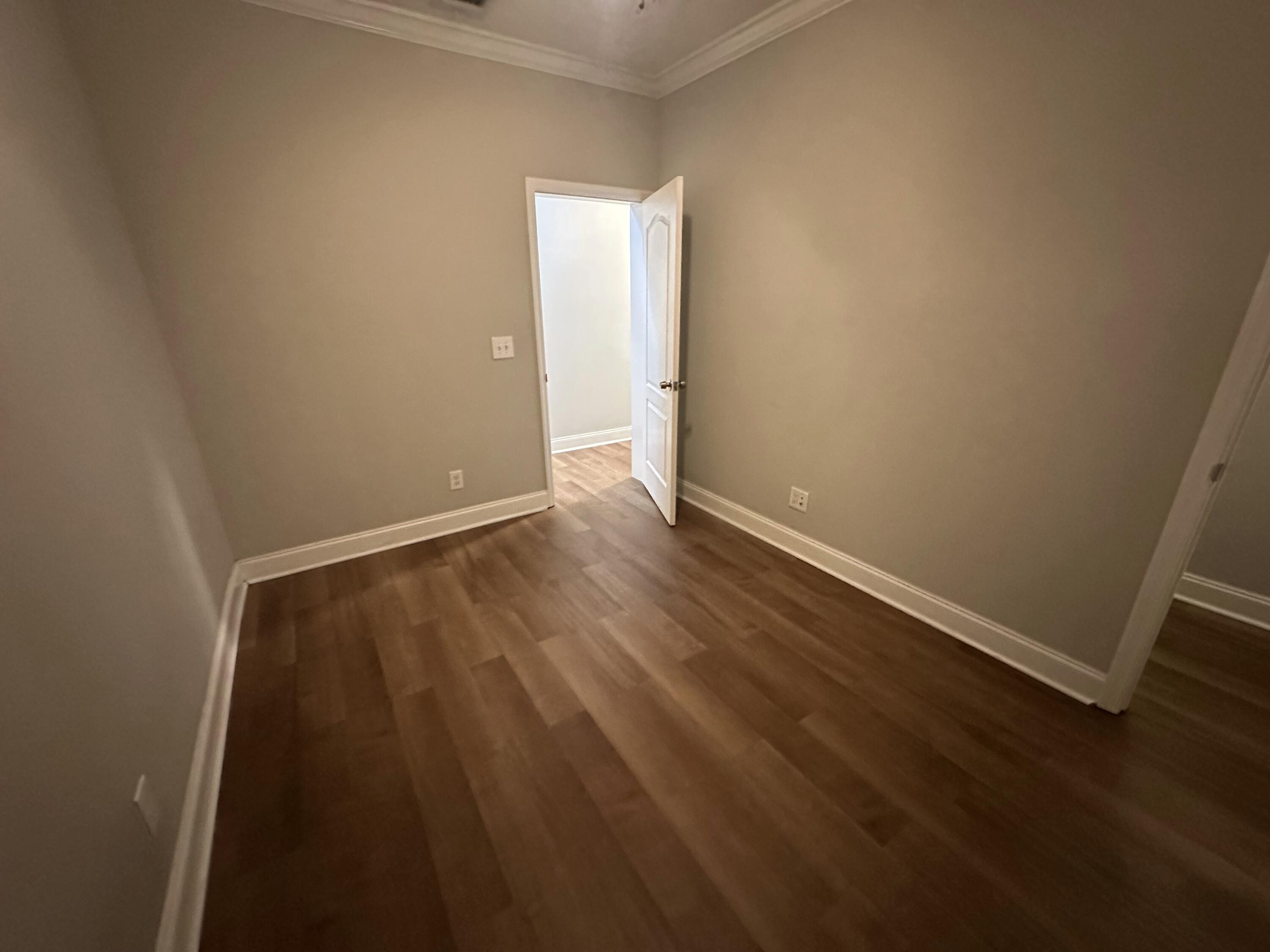 30964 Nathalie Road Big Pine Key, FL 33043 - Photo 7 of 10 an empty room with wooden floor and windows