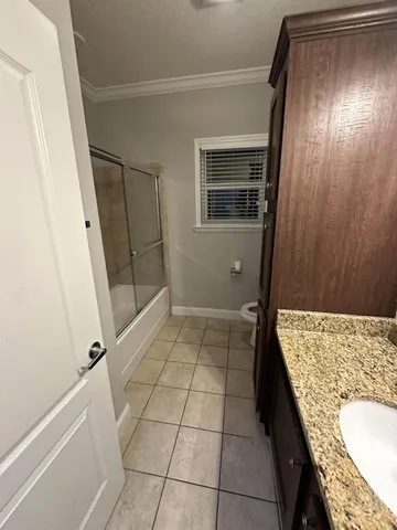 a bathroom with a granite countertop sink and mirror