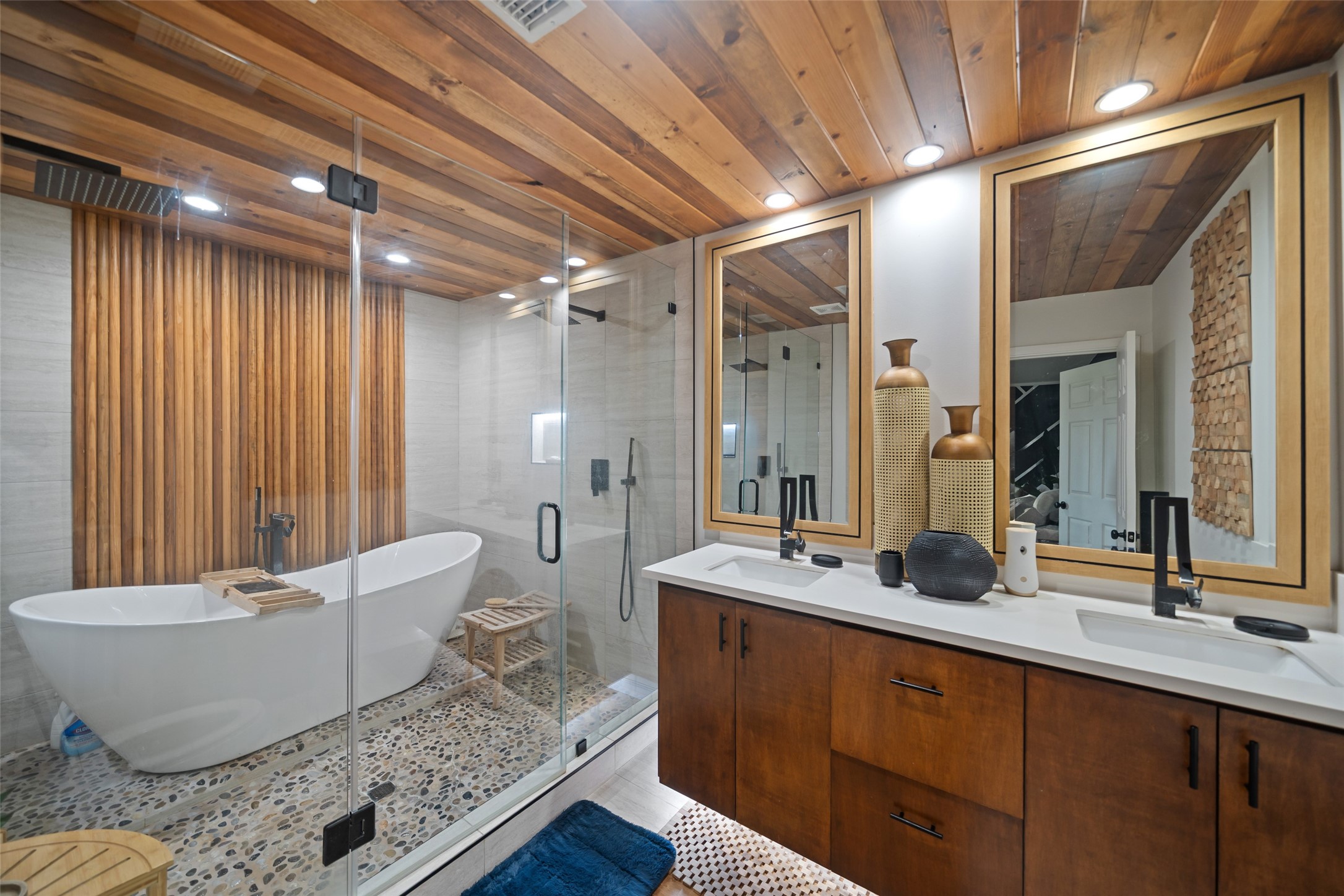 43910 Highway 290 Business Prairie View, TX 77484 - Photo 12 of 49 Spa-inspired primary bath featuring freestanding soaking tub, walk-in glass shower, wood accents, and dual vanity.