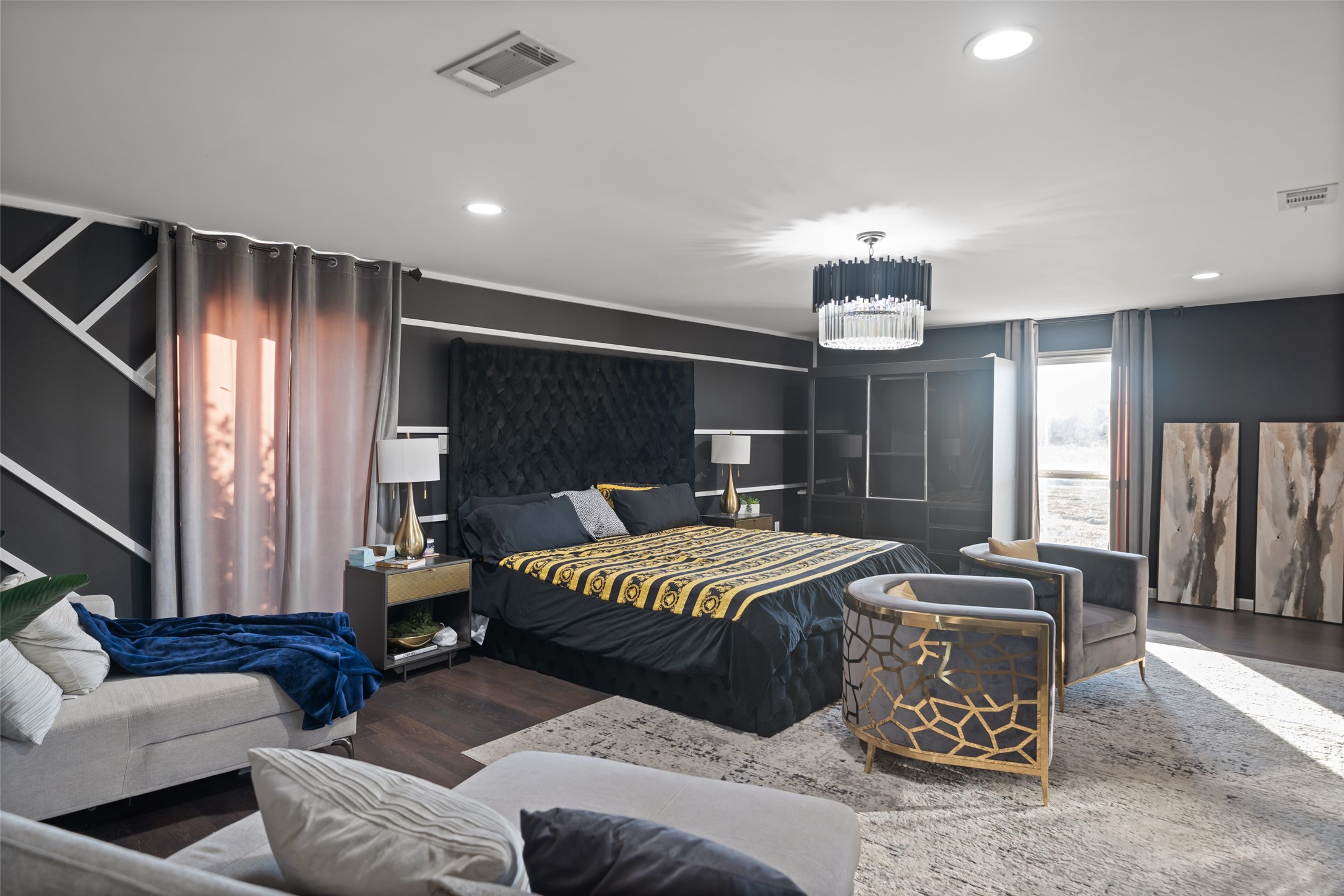 43910 Highway 290 Business Prairie View, TX 77484 - Photo 15 of 49 Oversized primary suite with sitting area, designer lighting, plush finishes, and elegant accent wall.