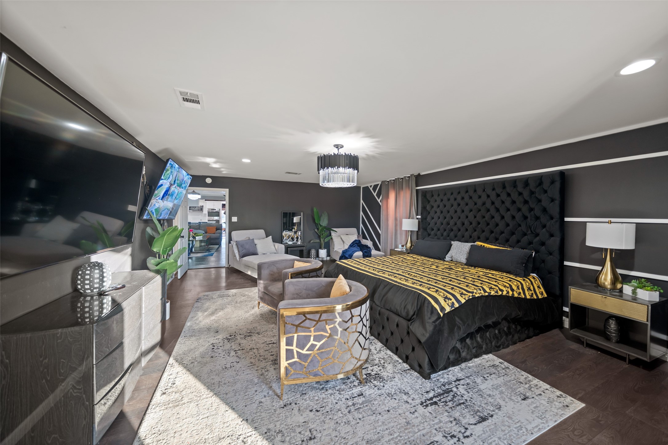 43910 Highway 290 Business Prairie View, TX 77484 - Photo 16 of 45 a bedroom with a bed a bookshelf and a flat screen tv