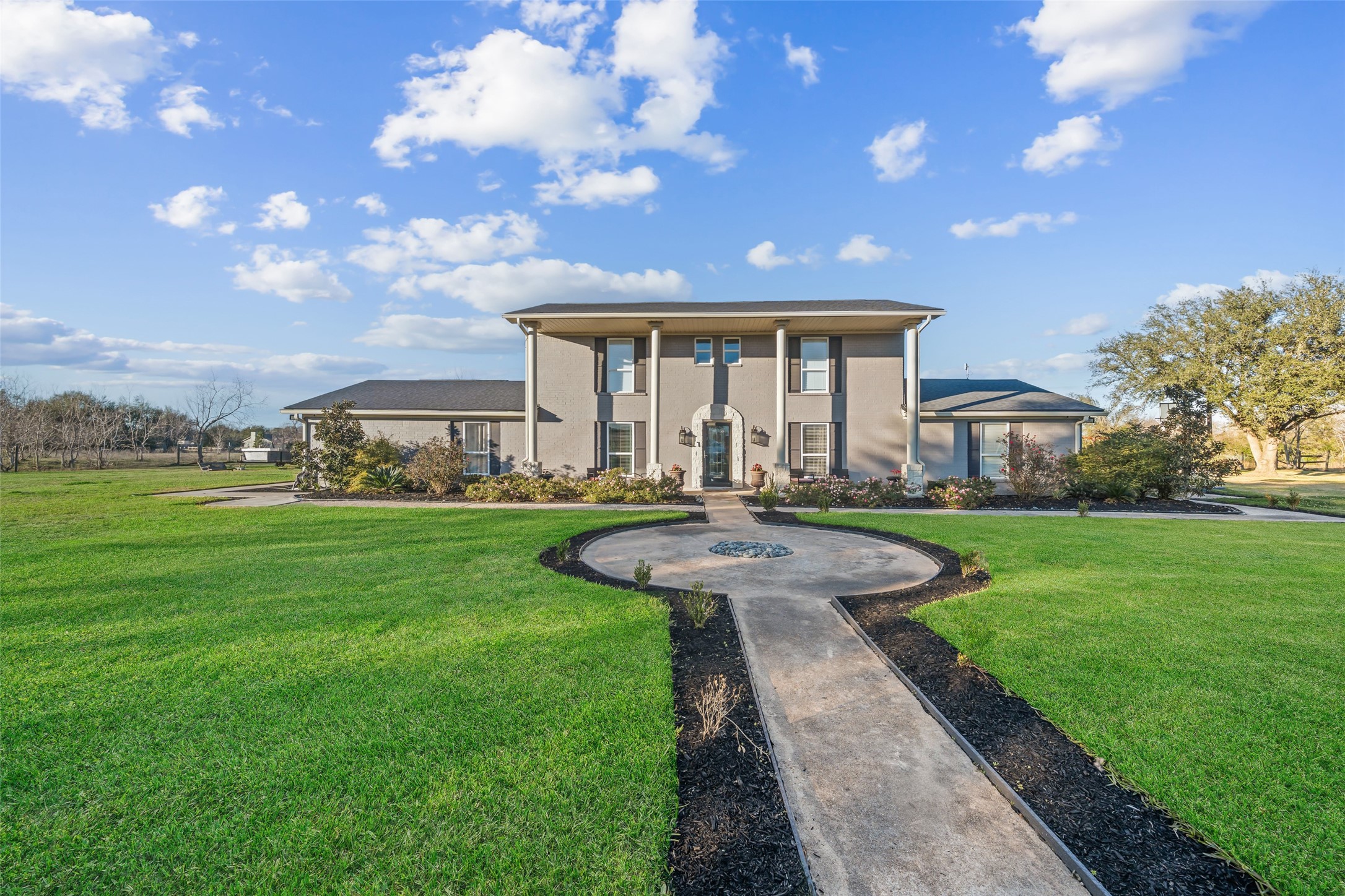 43910 Highway 290 Business Prairie View, TX 77484 - Photo 2 of 49 Stunning two story brick façade with columned entry, symmetrical design, and beautiful landscaping.