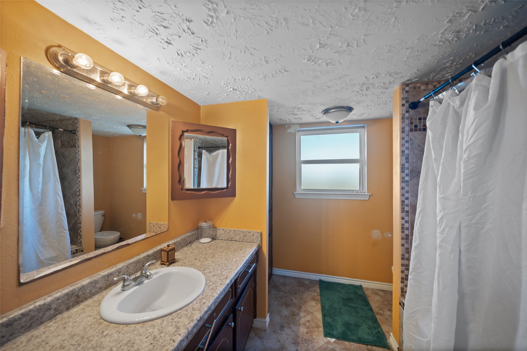 43910 Highway 290 Business Prairie View, TX 77484 - Photo 23 of 45 a bathroom with a sink a mirror and a shower