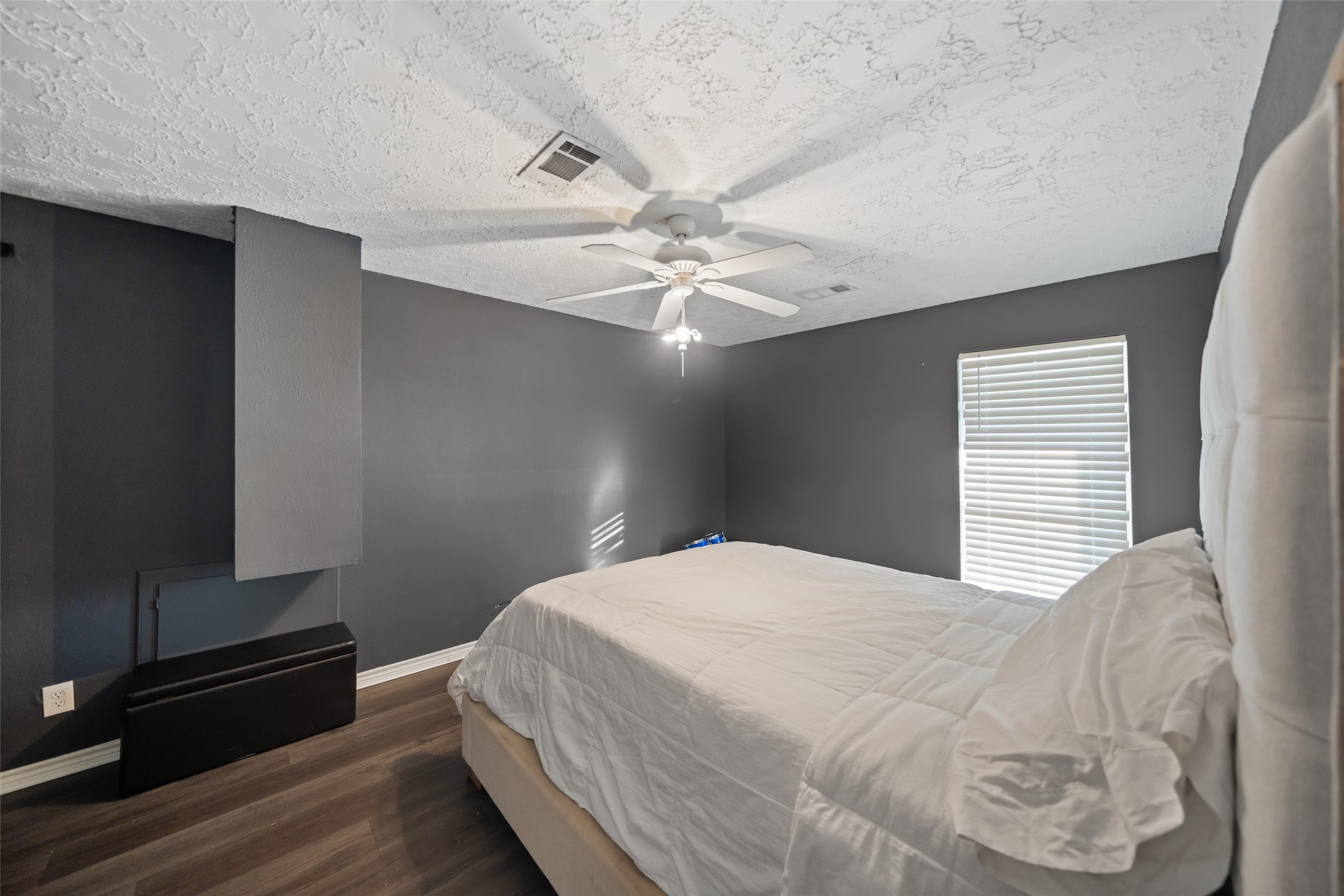 43910 Highway 290 Business Prairie View, TX 77484 - Photo 23 of 49 Comfortable bedroom with neutral tones, ceiling fan, and wood-style flooring.