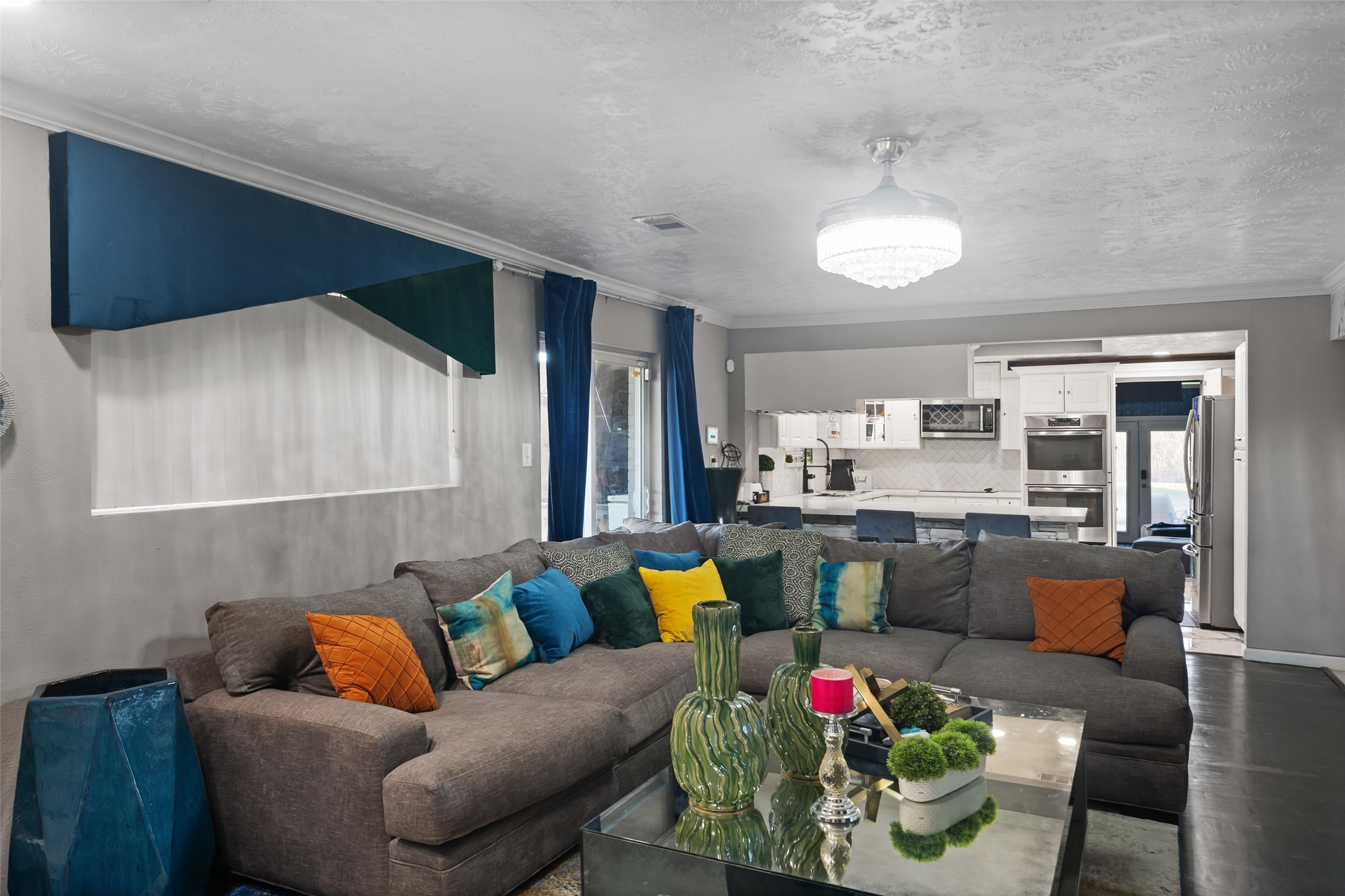 43910 Highway 290 Business Prairie View, TX 77484 - Photo 24 of 49 Open-concept living area with oversized sectional, chandelier lighting, and seamless flow to kitchen.