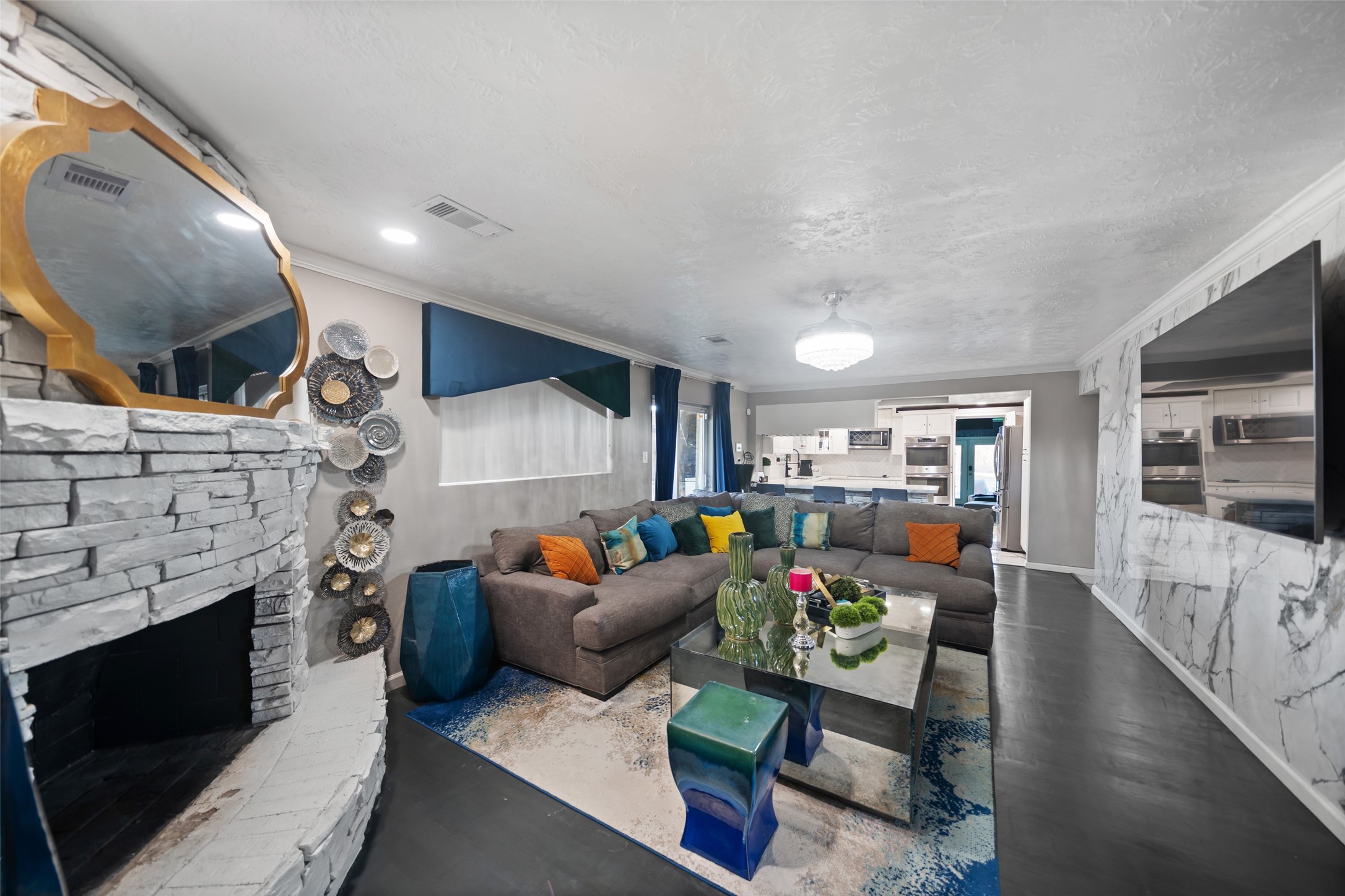 43910 Highway 290 Business Prairie View, TX 77484 - Photo 25 of 49 Spacious family room with stone fireplace and marble-style accent wall.