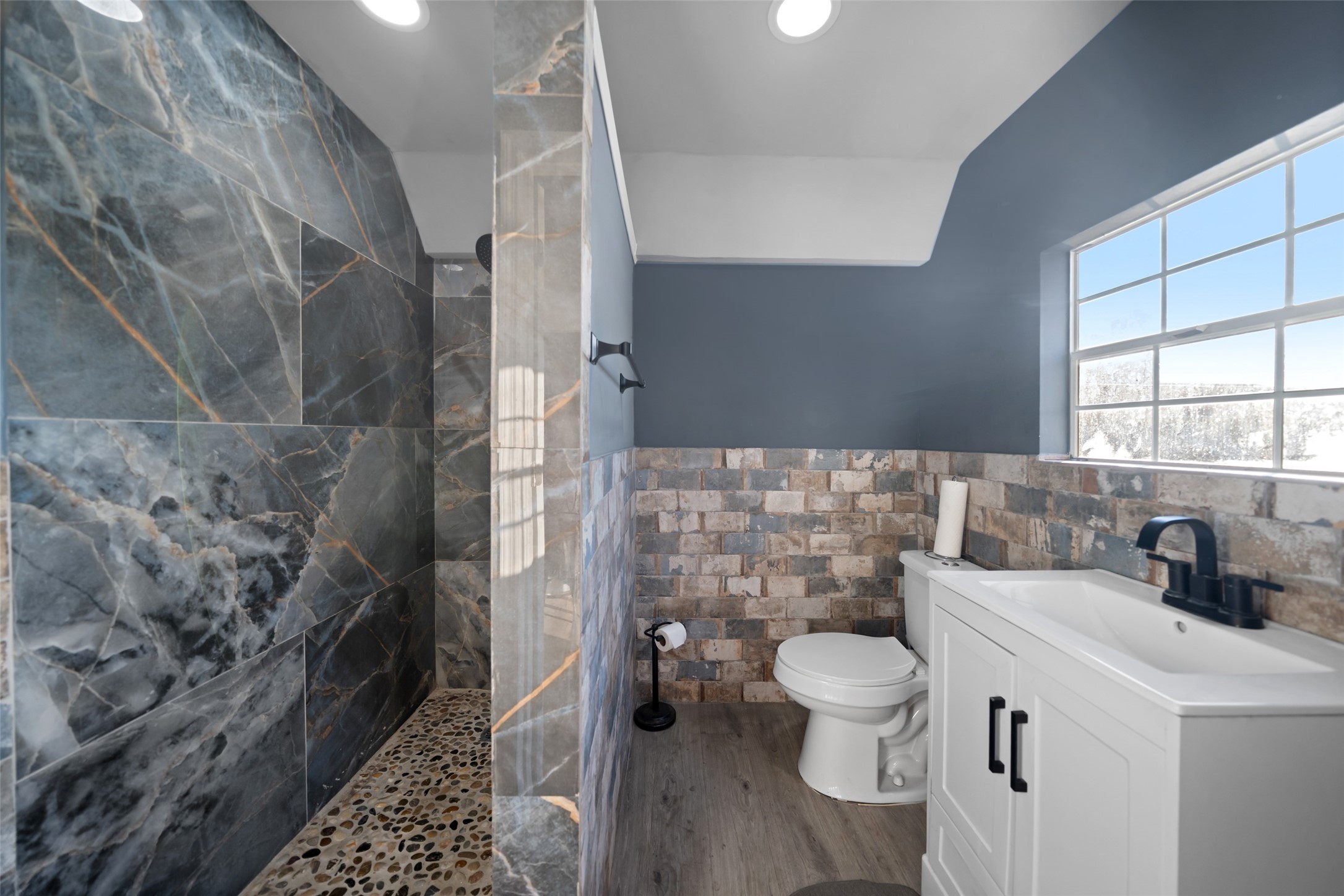 43910 Highway 290 Business Prairie View, TX 77484 - Photo 31 of 49 Updated bathroom featuring a large tiled walk-in shower, modern vanity, and natural light.