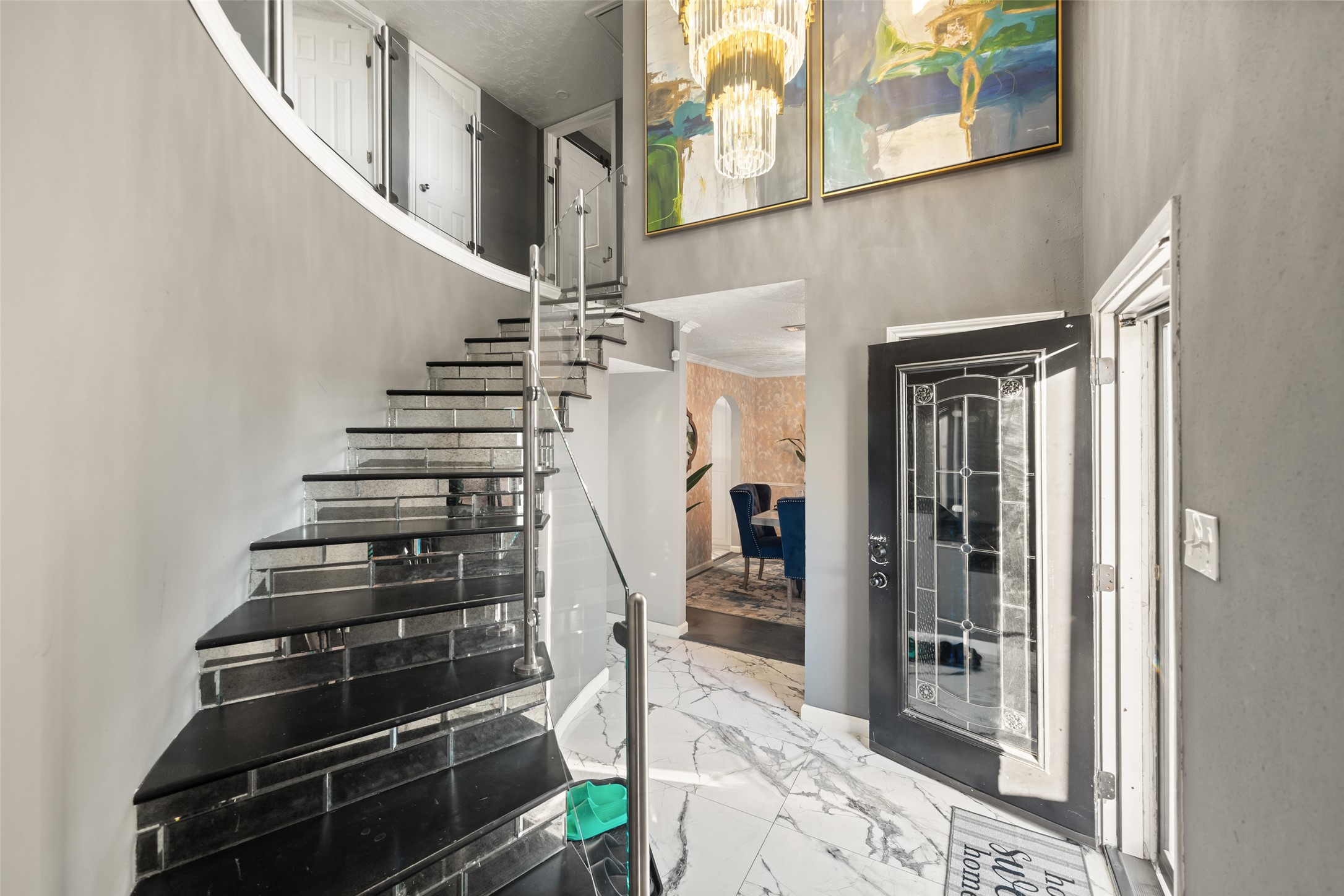 43910 Highway 290 Business Prairie View, TX 77484 - Photo 4 of 49 Contemporary staircase with glass railing and sleek details creating a striking first impression.