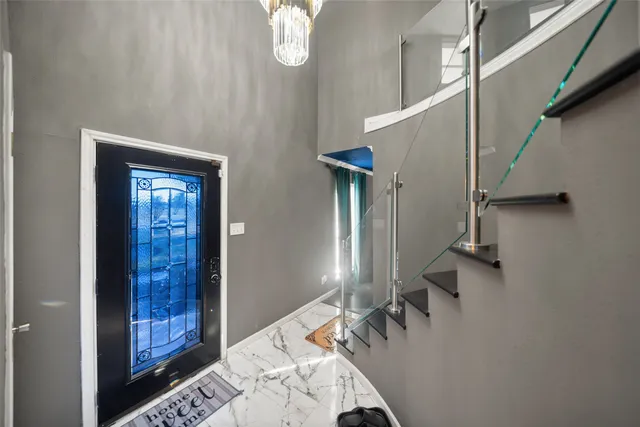 a kitchen with granite countertop white cabinets and stainless steel appliances
