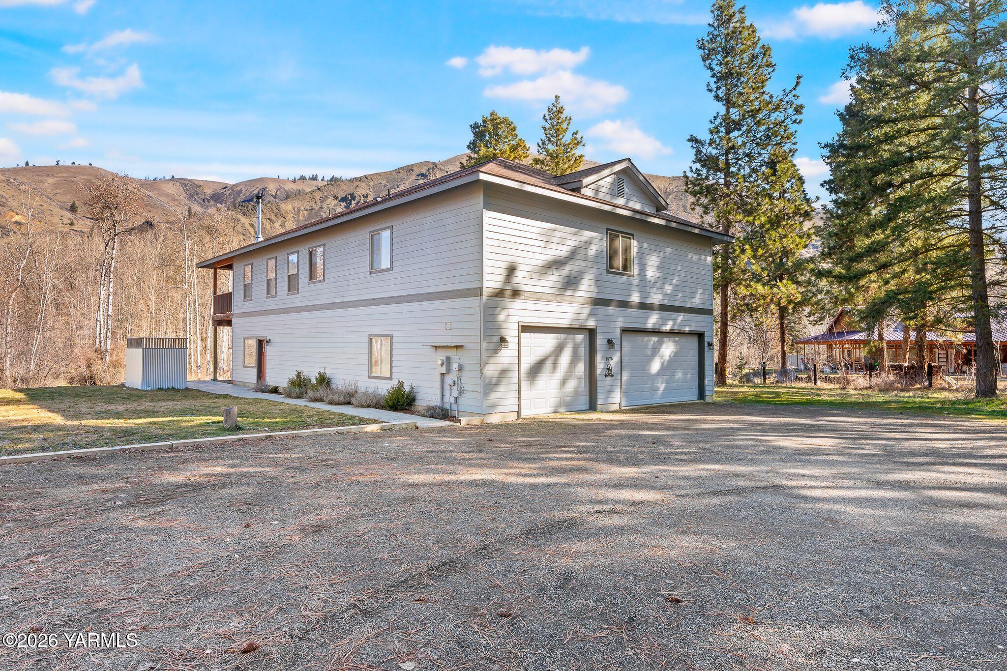 1575 Nile Road Naches, WA 98937 - Photo 3 of 51 a view of a house with a yard and a large tree