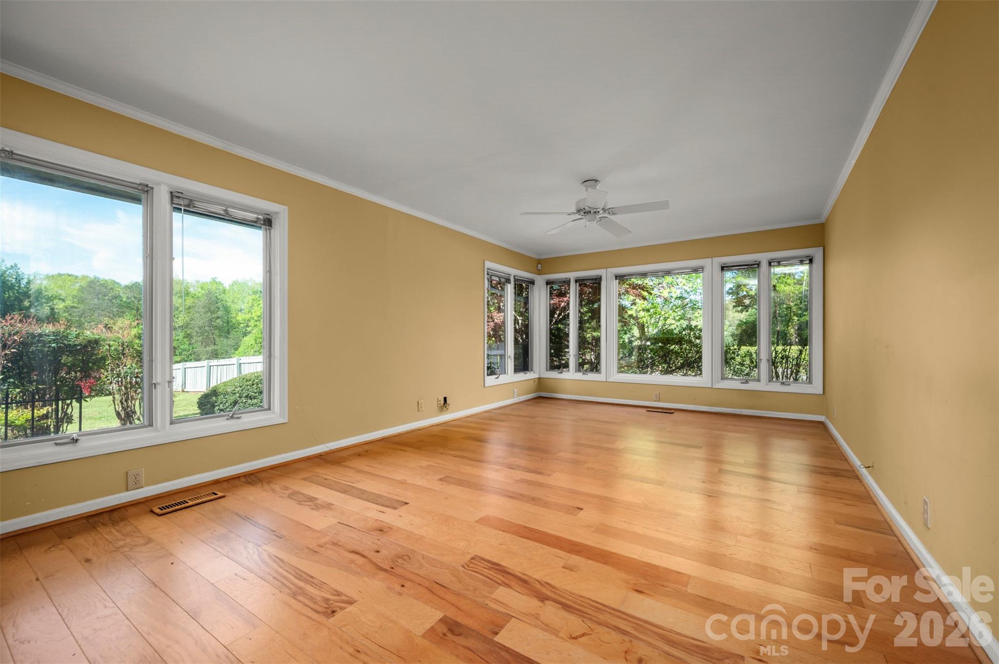 176 Fox Run Lane Tryon, NC 28782 - Photo 17 of 44 a view of an empty room with a window and wooden floor