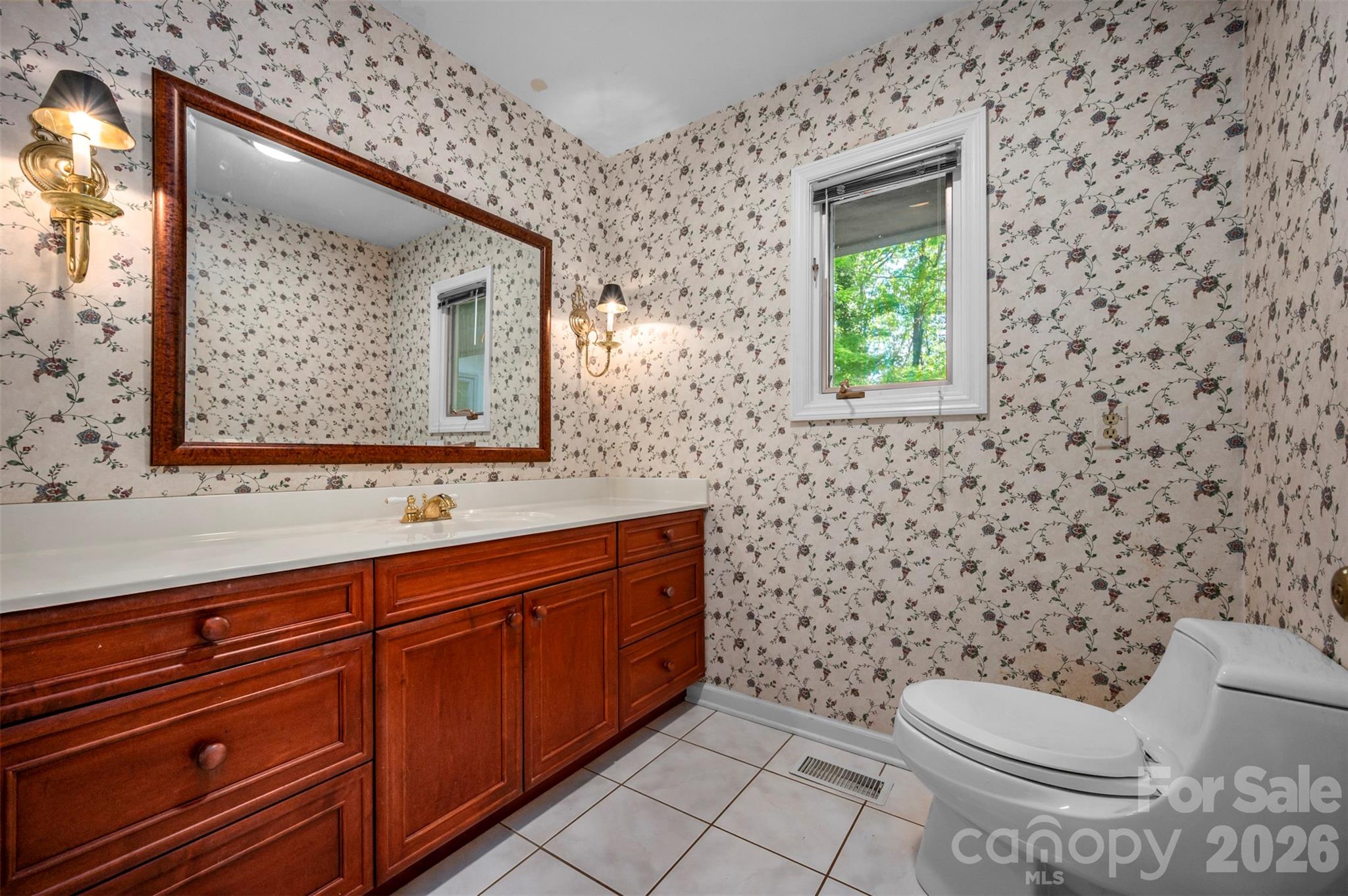 176 Fox Run Lane Tryon, NC 28782 - Photo 18 of 44 a bathroom with a toilet sink and mirror