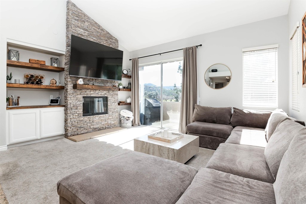 3259 Dehesa Road, Unit 61 El Cajon, CA 92019 - Photo 1 of 1 a living room with furniture flat screen tv and a fireplace