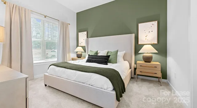 a bedroom with a bed and a lamp