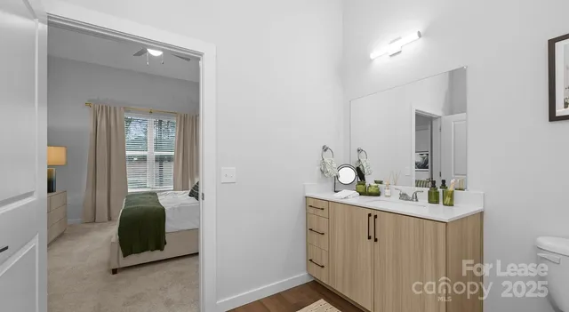 a en suite bathroom with a double vanity sink a mirror and a bathtub