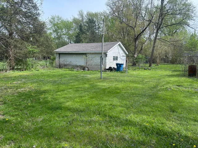 a house with huge green field in front of it