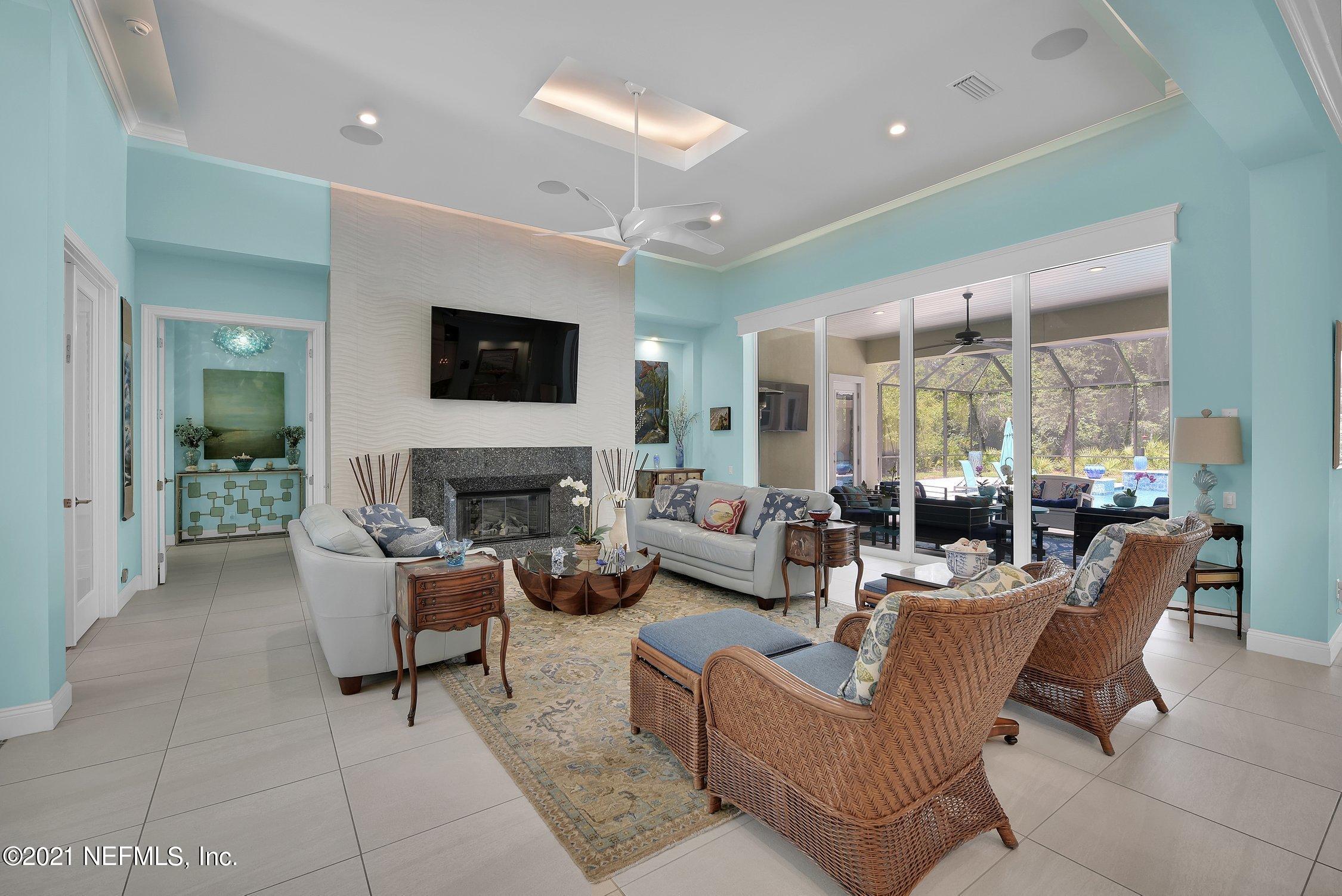 496 Costa Del Sol Drive St. Augustine, FL 32095 - Photo 14 of 111 a living room with furniture a flat screen tv and a fireplace
