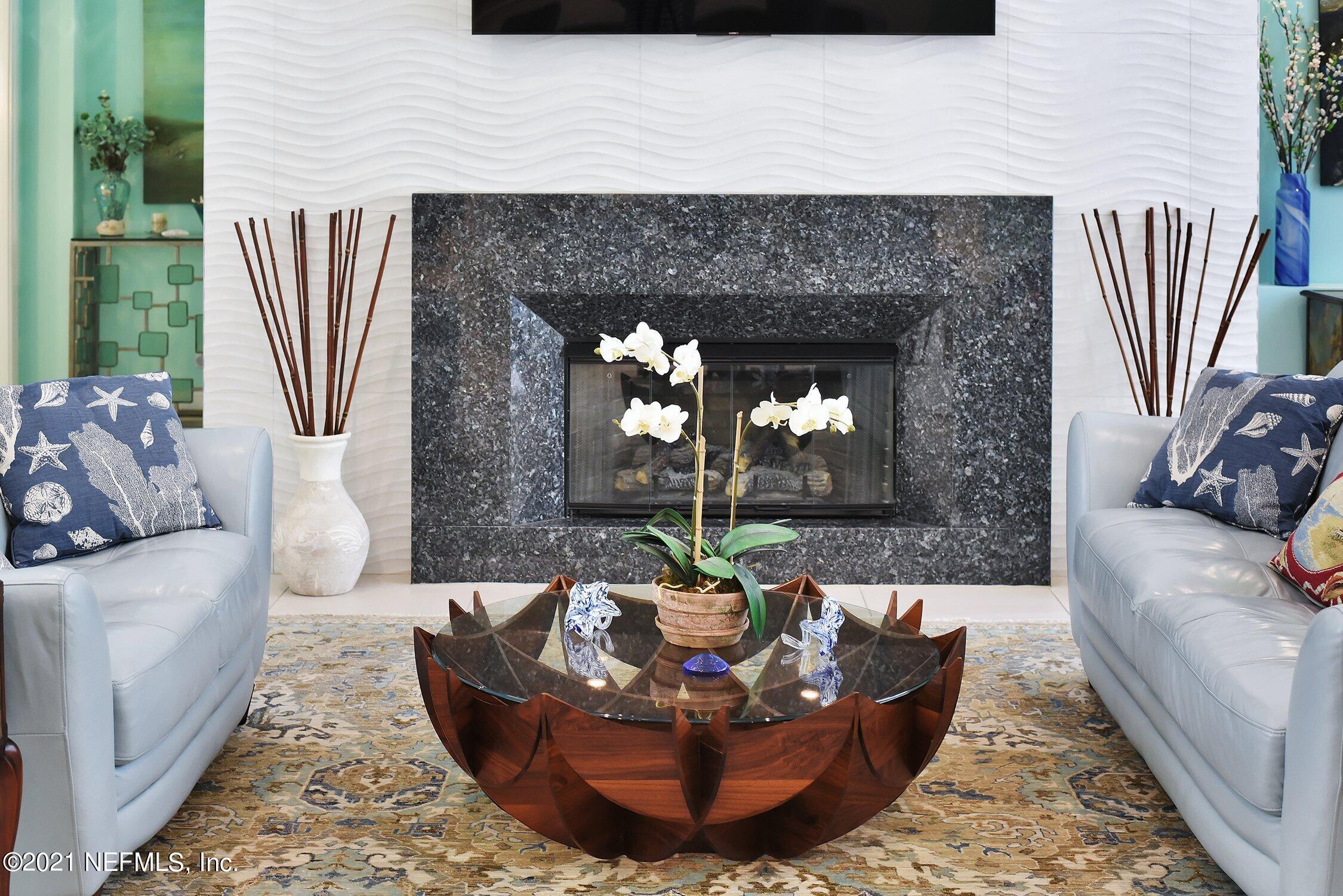 496 Costa Del Sol Drive St. Augustine, FL 32095 - Photo 16 of 111 a living room with furniture a fireplace and a large window