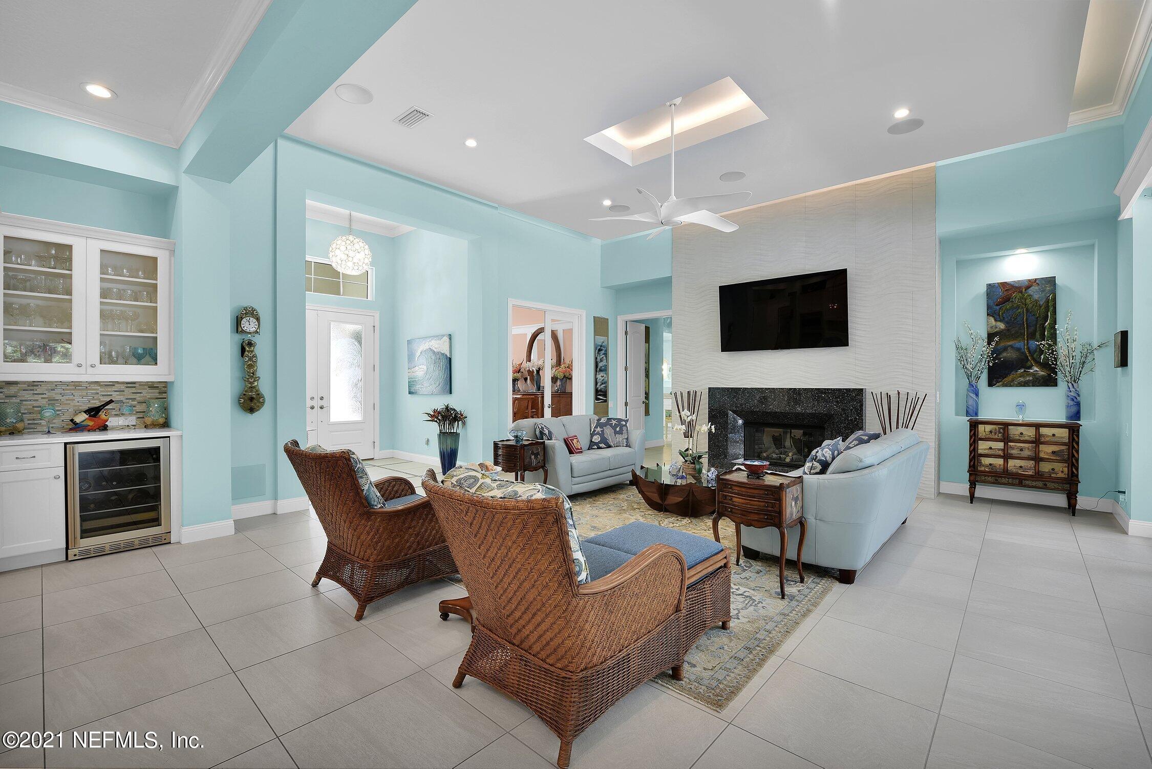 496 Costa Del Sol Drive St. Augustine, FL 32095 - Photo 18 of 111 a living room with furniture a fireplace and a flat screen tv