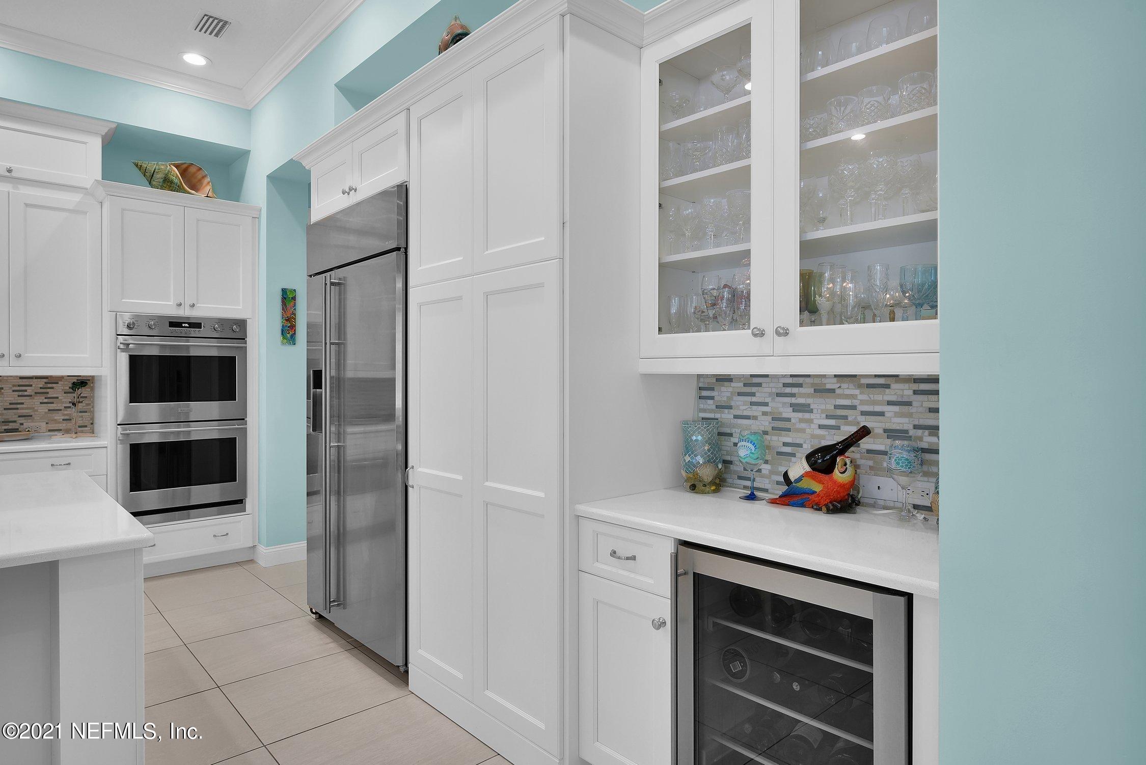 496 Costa Del Sol Drive St. Augustine, FL 32095 - Photo 29 of 111 a kitchen with stainless steel appliances a refrigerator and a stove top oven