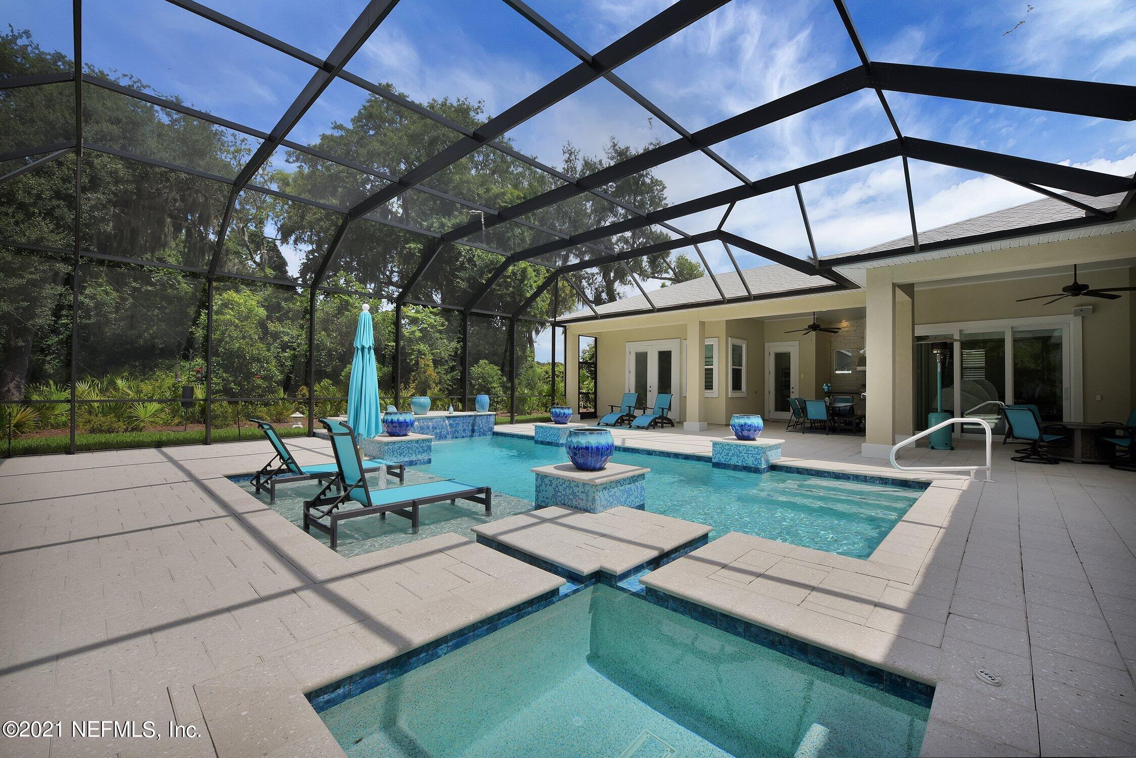 496 Costa Del Sol Drive St. Augustine, FL 32095 - Photo 3 of 111 a view of a patio with a table and chairs under an umbrella