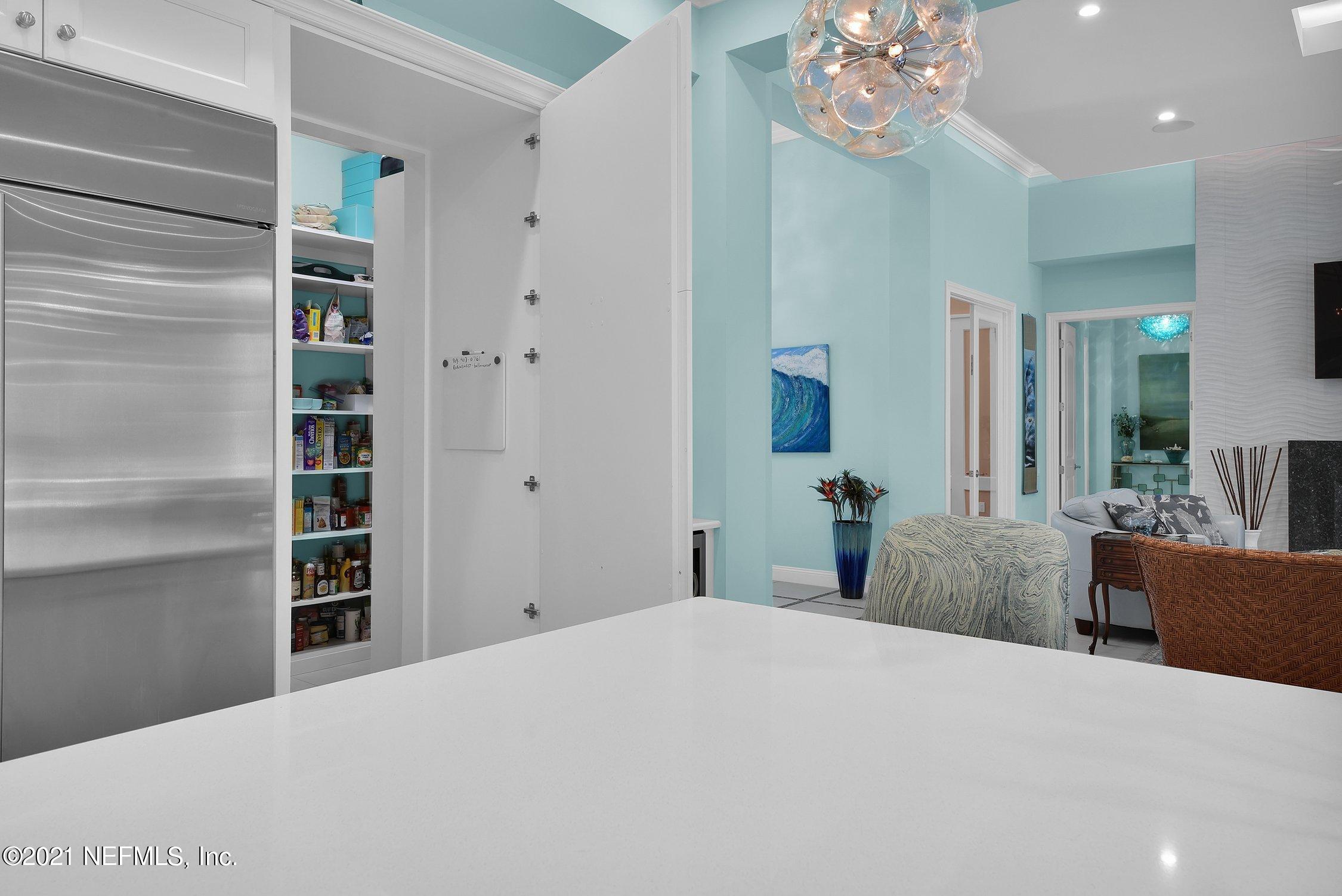 496 Costa Del Sol Drive St. Augustine, FL 32095 - Photo 31 of 111 a bedroom with a bed and a chandelier